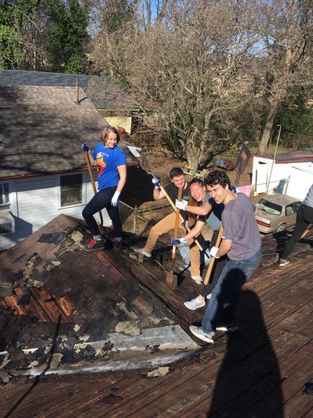 Students completing construction project on roof during alternative break with Habitat for Humanity Birmingham
