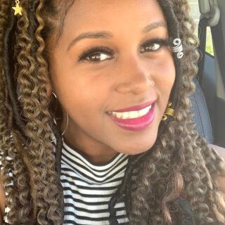 A smiling woman in a striped shirt