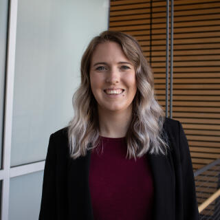 a white women with blonde hair in a blazer smiling