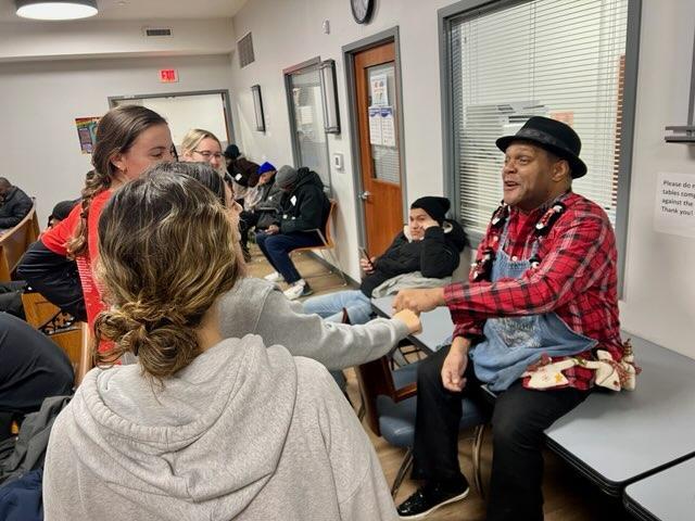 College student volunteers greeting individuals at Father McKenna Center