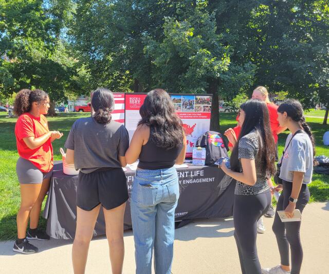 Students gathered around the Buck-I-SERV table for fall 2023 student involvement fair