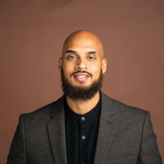 a professional image of Anthony in a suite.