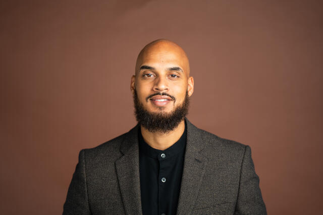 a professional image of Anthony in a suite.