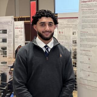 Amjad smiling at camera.