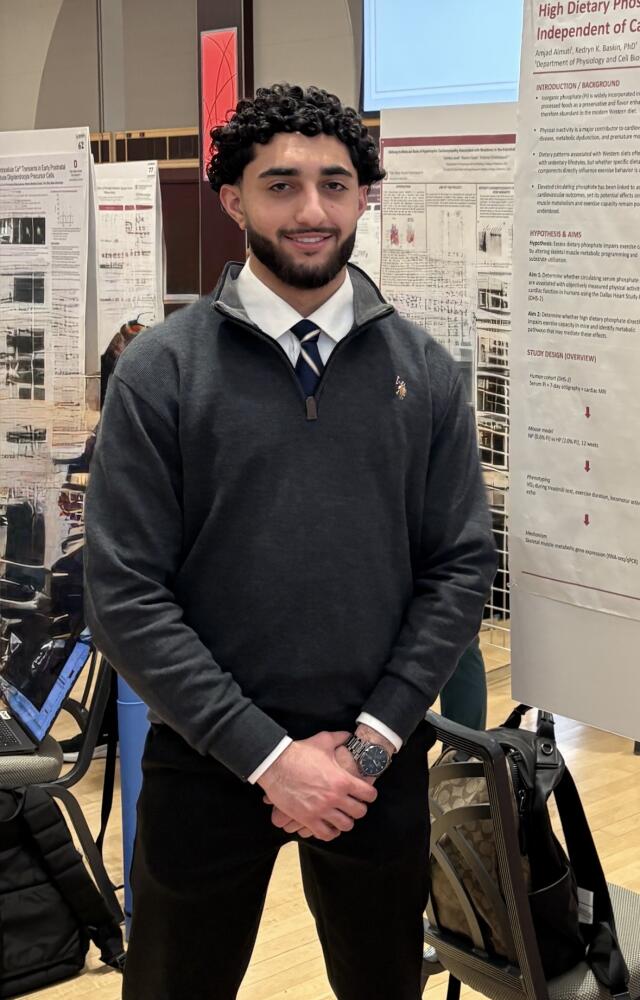 Amjad smiling at camera.