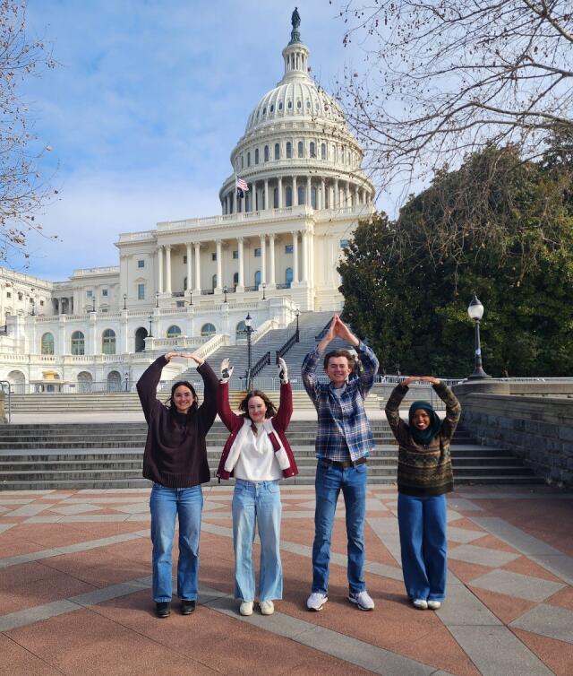 Four students pose as O-H-I-O in front of the Capitol Building in Washington DC
