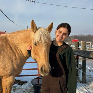Daniela smiling with horse.