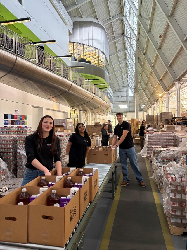 Students packing food boxes to deliver in the community for Focus HOPE