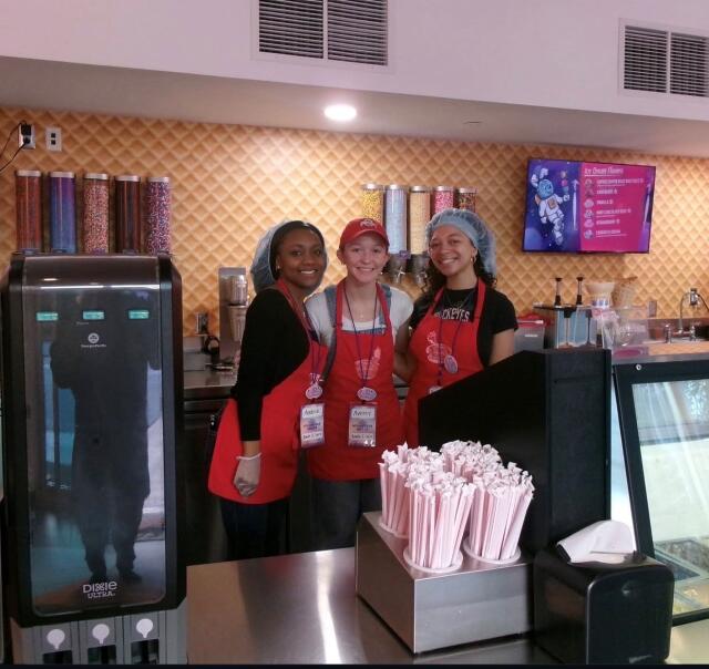 Three student volunteers working the ice cream shoppe at Give Kids the World.