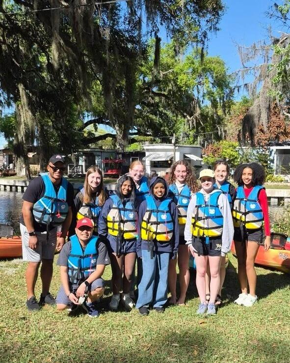 Group of students in life jackets by a lake in Spring 2026