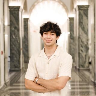 Humza smiling at the camera.