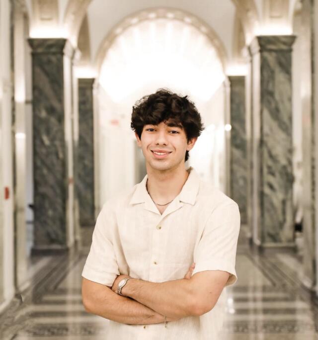 Humza smiling at the camera.