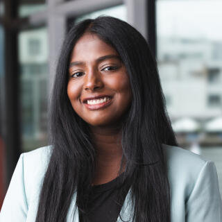 Ahalya smiling at the camera.