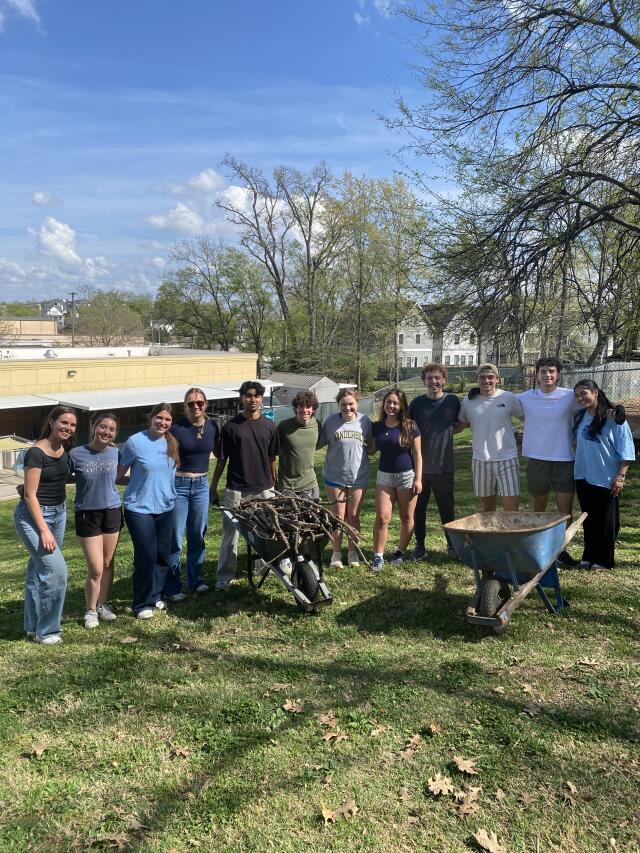 A group of volunteers cleans up the outdoor space at the Nashville Humane Association