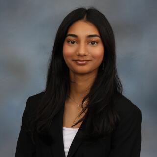 Khushi smiling at the camera.