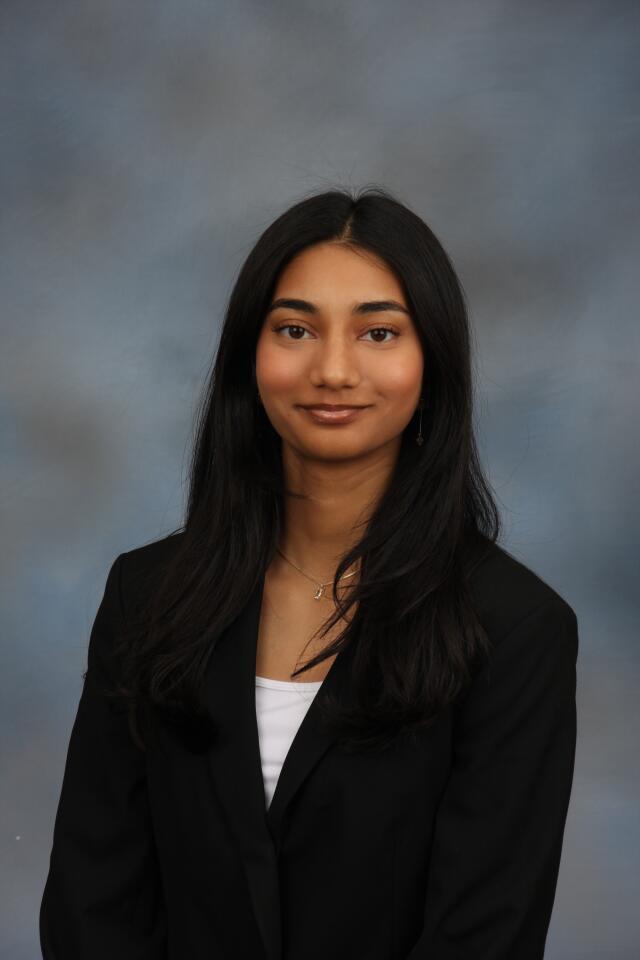 Khushi smiling at the camera.