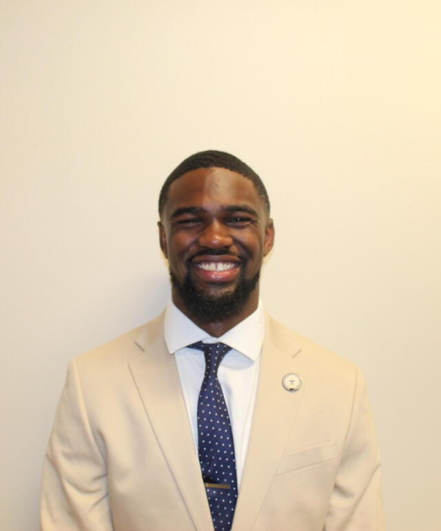 Isaac smiling at the camera.