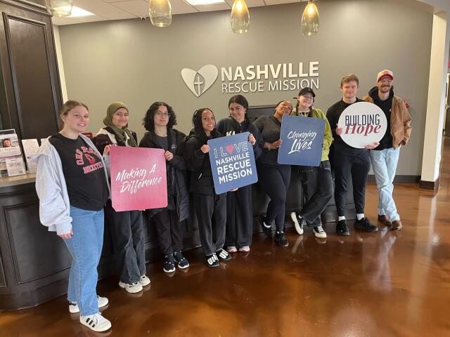 A group of 9 students pause for a photo while serving at Nashville Rescue Mission
