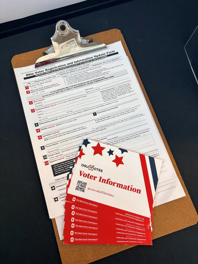 A picture of an Ohio voter registration form on a clipboard with an OSU Votes info card.