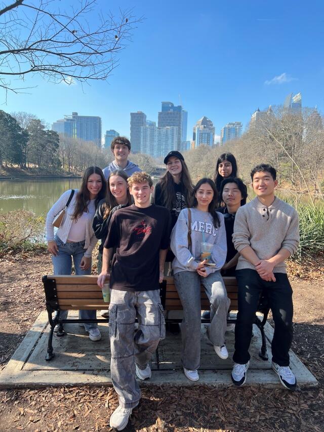Buck-I-SERV Students posing for a photo with the Atlanta Skyline behind them.