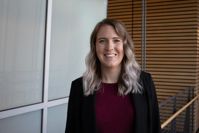 a white women with blonde hair in a blazer smiling
