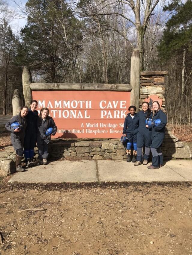 College students posing in front of orange Mammoth Cave National Park sign