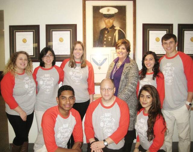 College student volunteers posing with Veterans Affairs Medical Center staff member