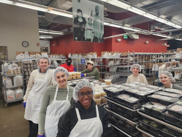 Students prepare meals while serving with Food and Friends in Washington DC